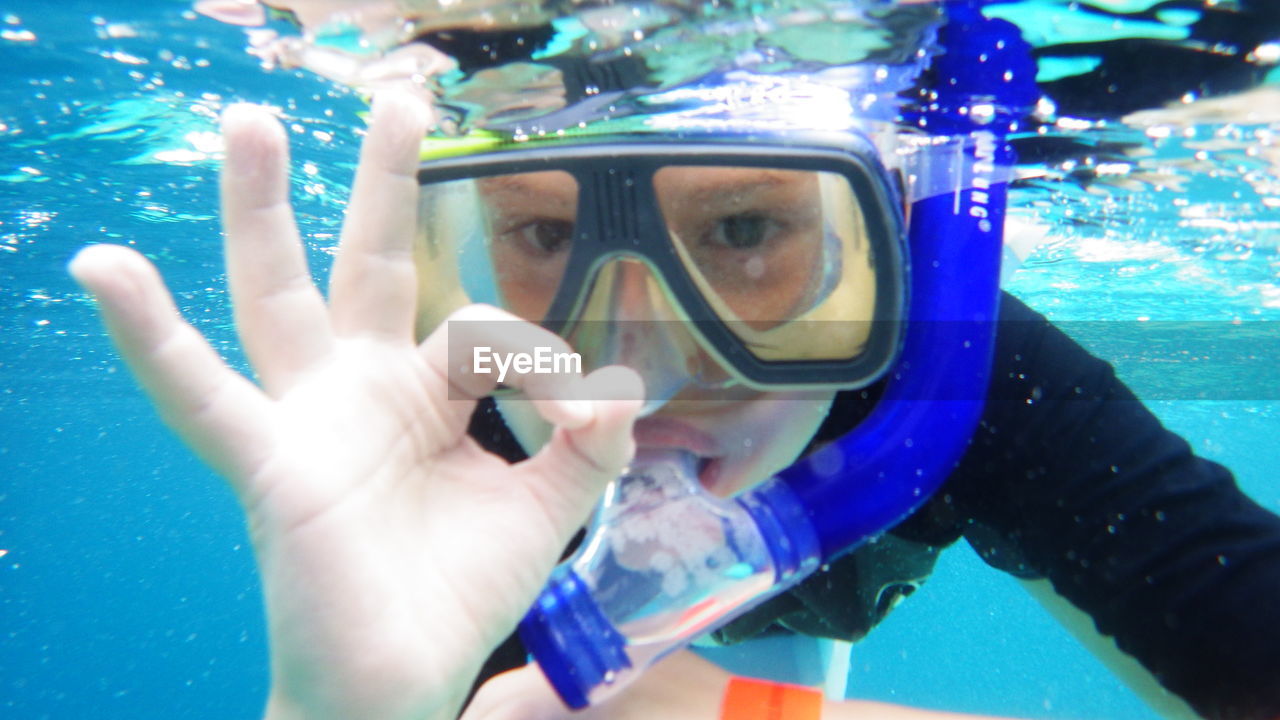 Close-up of child snorkeling underwater