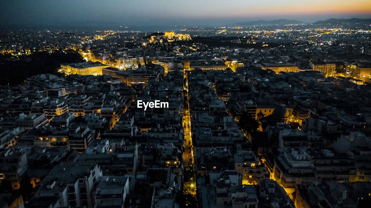 Aerial view of city lit up at night