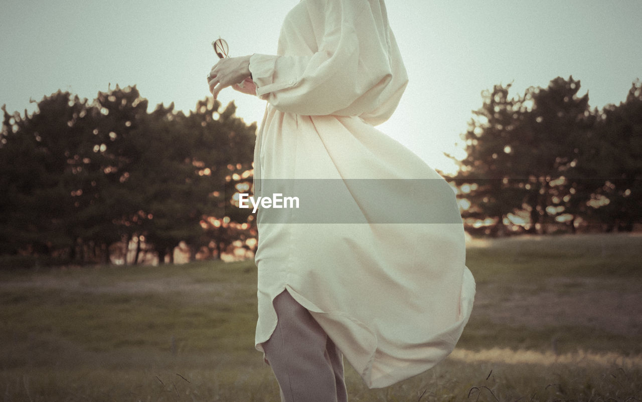 Side view of woman standing on field