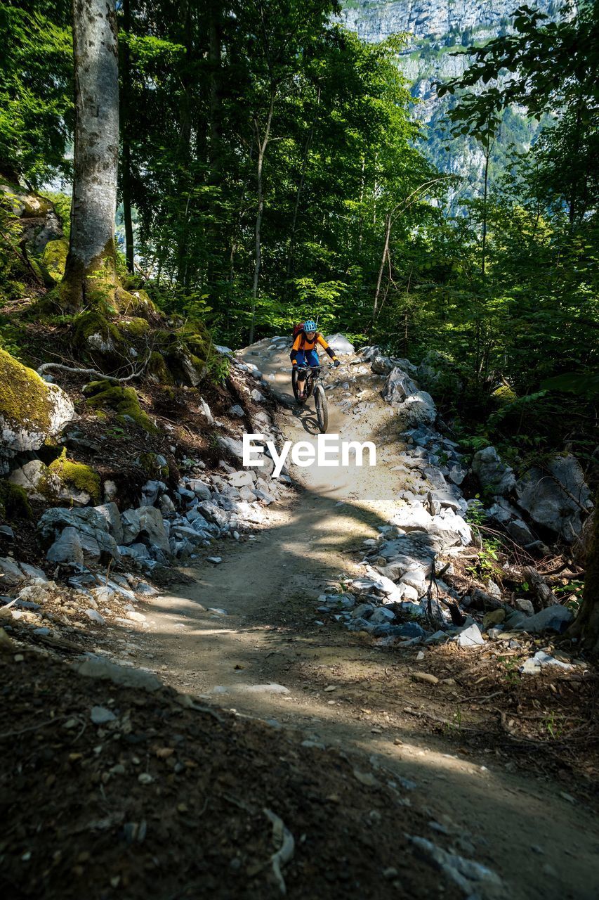 Woman riding a mountain bike on a flow trail in a bike park in glarus, switzerland.