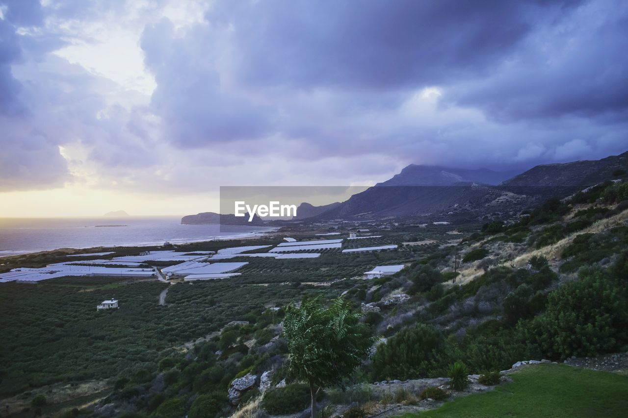 Scenic view of sea and mountains against sky