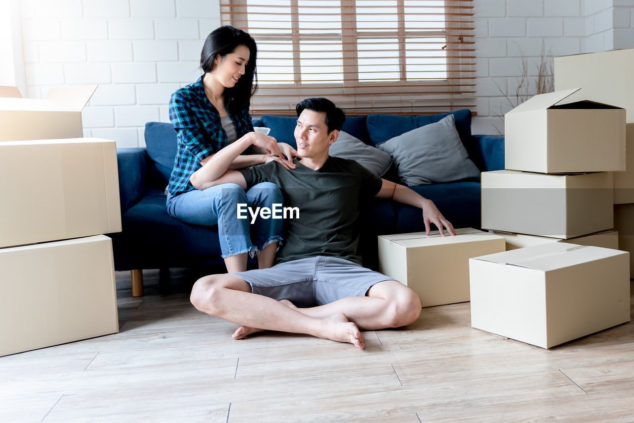 YOUNG COUPLE SITTING IN THE BOX