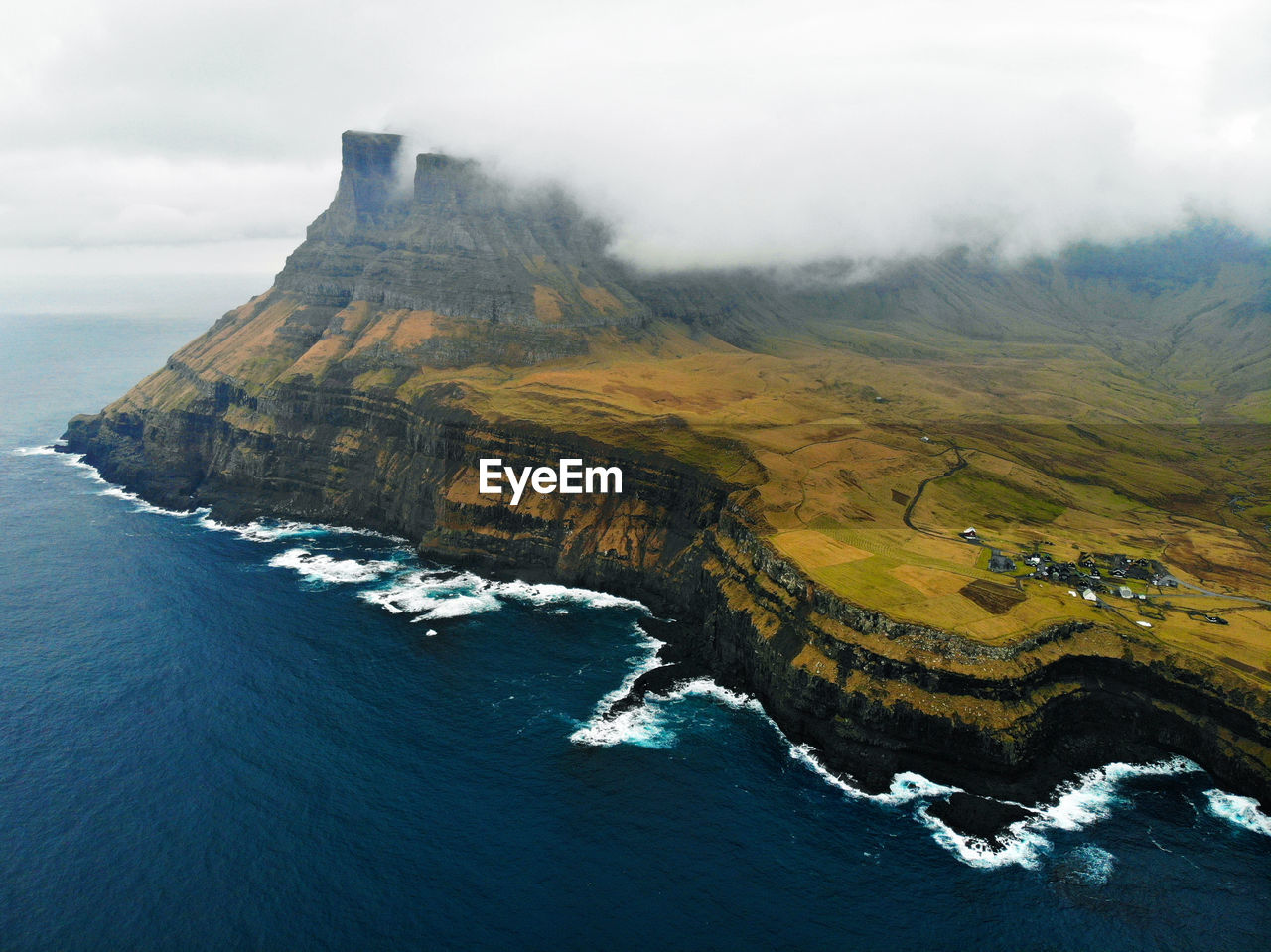 Aerial view of land and sea against sky