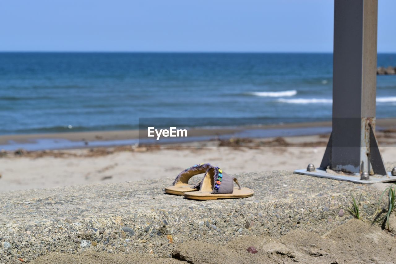 VIEW OF SHOES ON BEACH