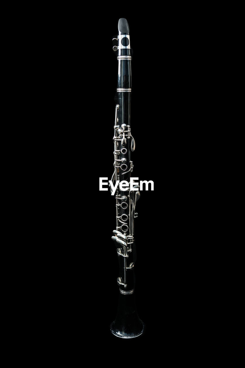 Close-up of flute against black background