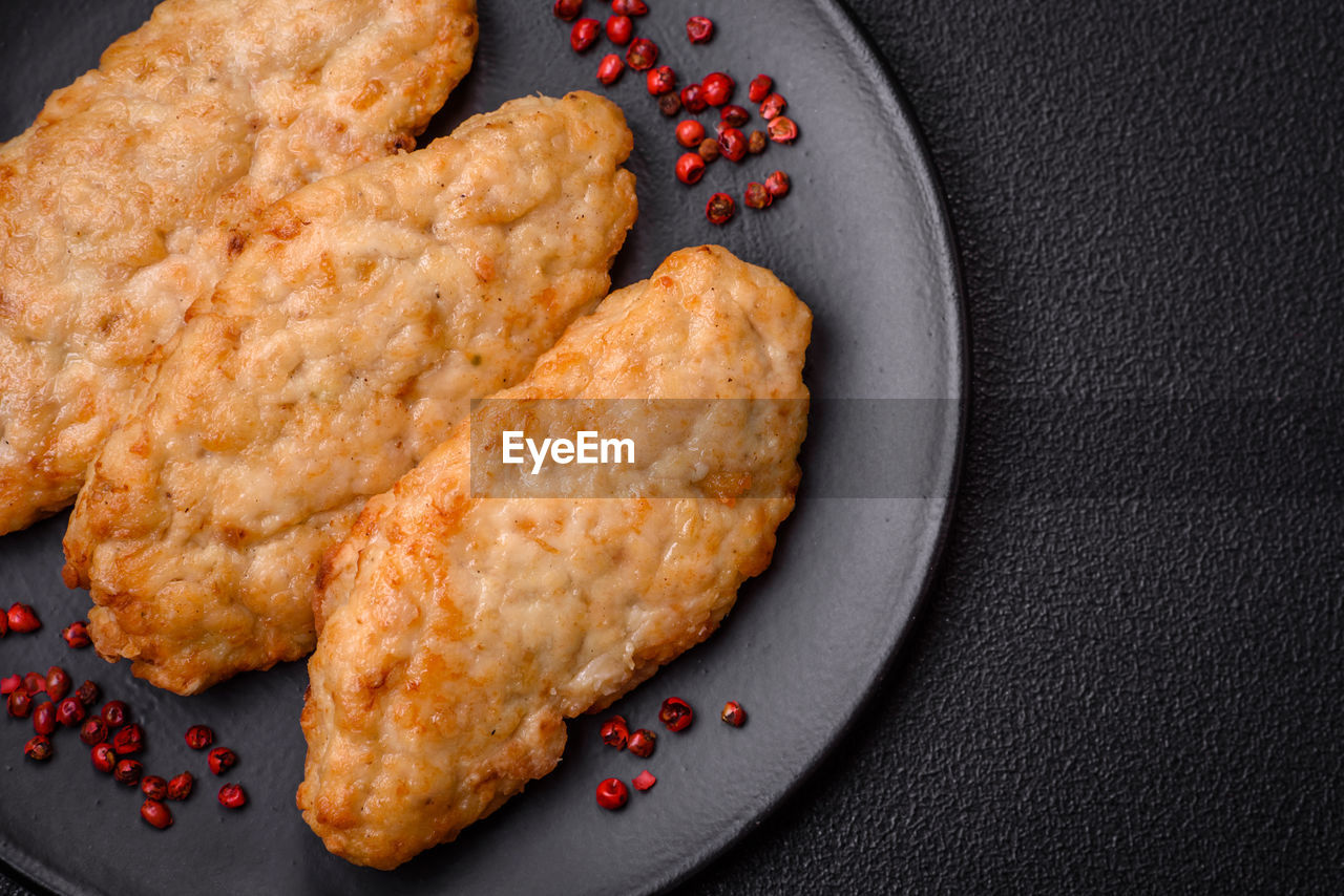 food and drink, food, dish, baked, produce, freshness, no people, fried food, fried, snack, studio shot, sweet food, indoors, dessert, cookie, fast food, black background, fruit, high angle view, unhealthy eating, plate, cookies and crackers, close-up, meal, still life, meat