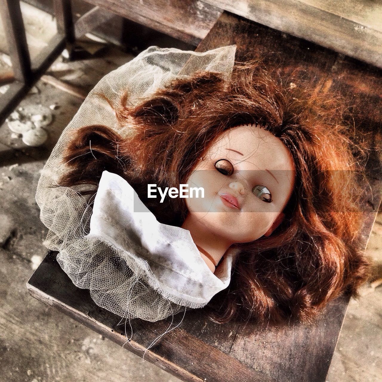 High angle view of abandoned spooky doll on table at home