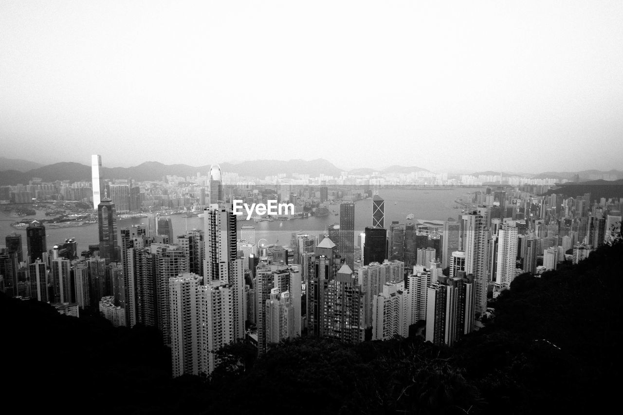 Aerial view of buildings in city against sky