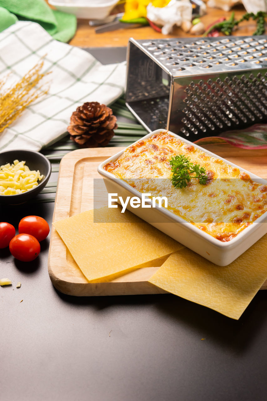 High angle view of lasagne in container on cutting board