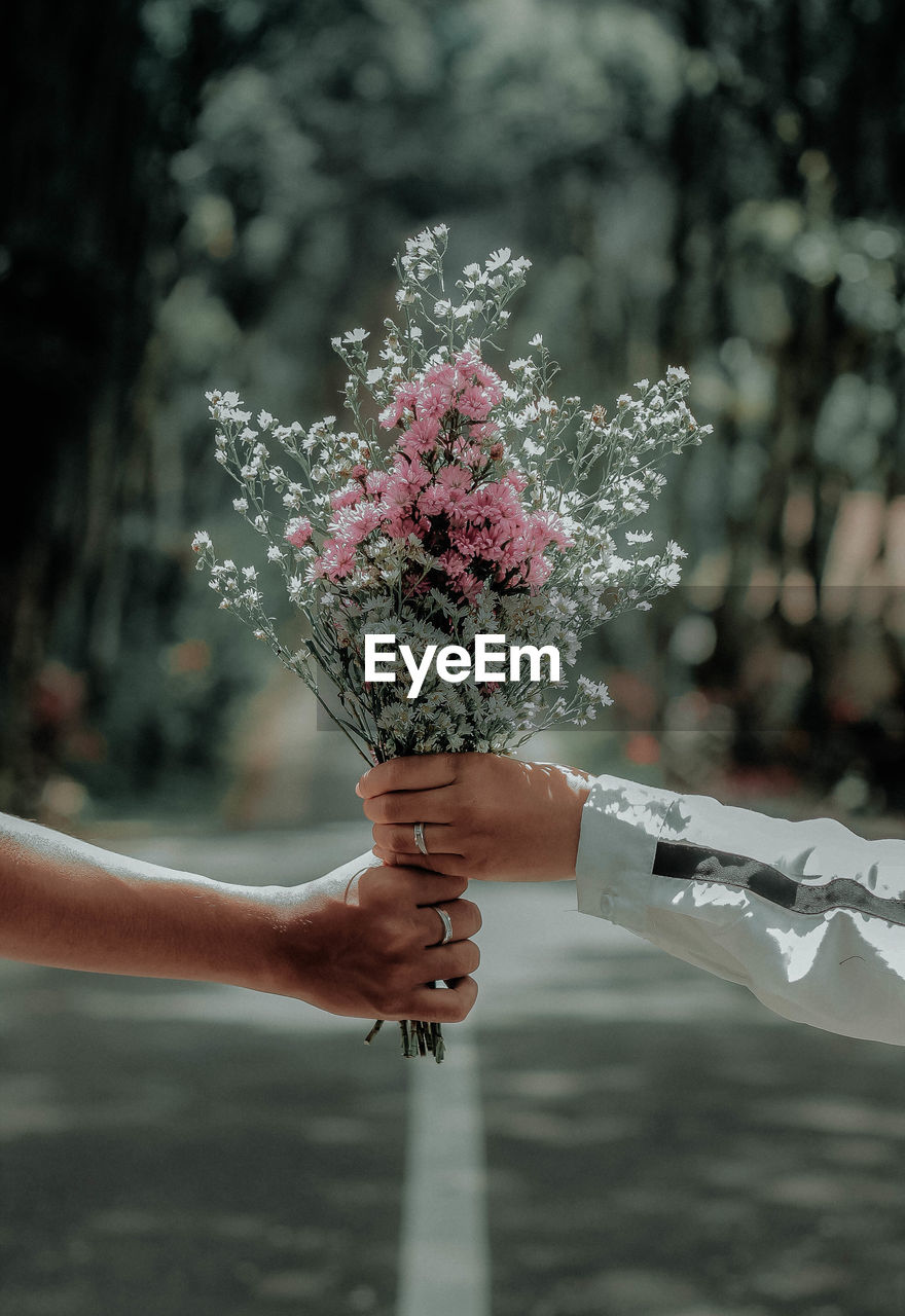 Man and woman holding bouquet
