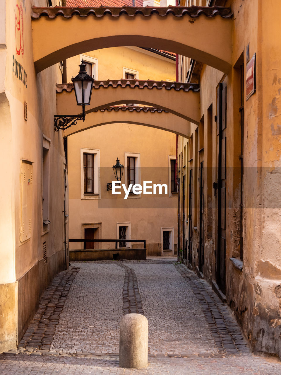 VIEW OF EMPTY ALLEY AMIDST BUILDINGS