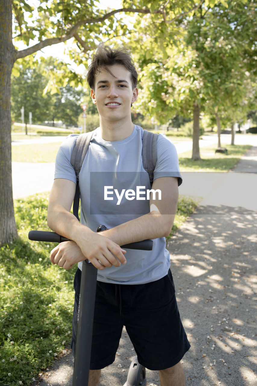 low section of man holding book