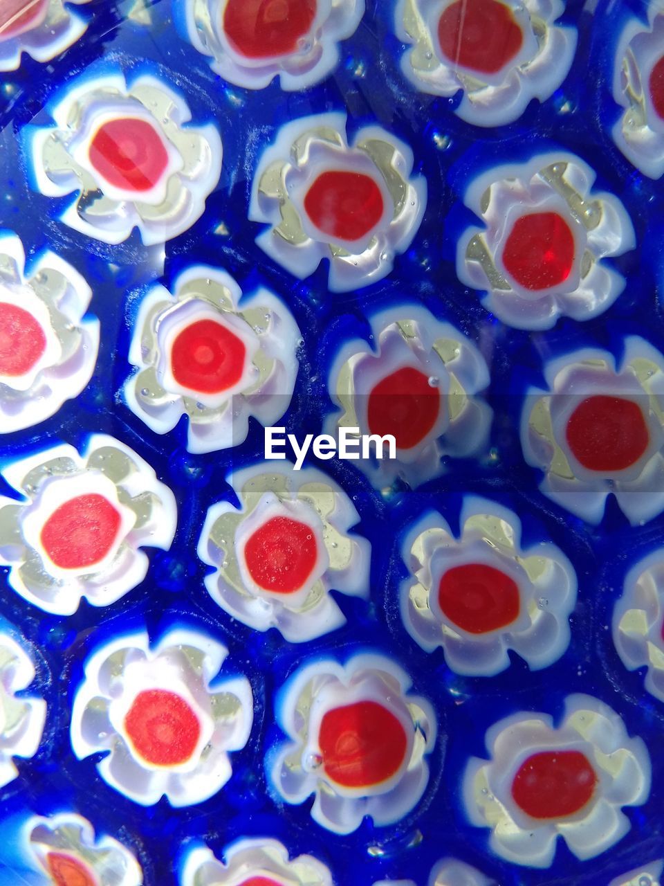 HIGH ANGLE VIEW OF MULTI COLORED CANDIES ON BLUE TABLE