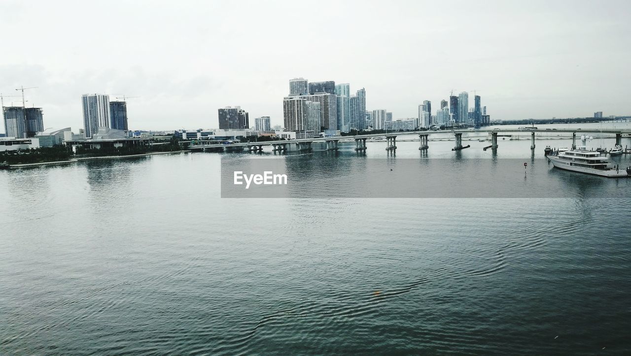 City by river against sky