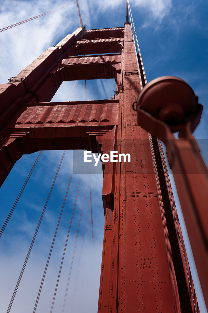 In touch with the sky, golden gate bridge pillar low angle view