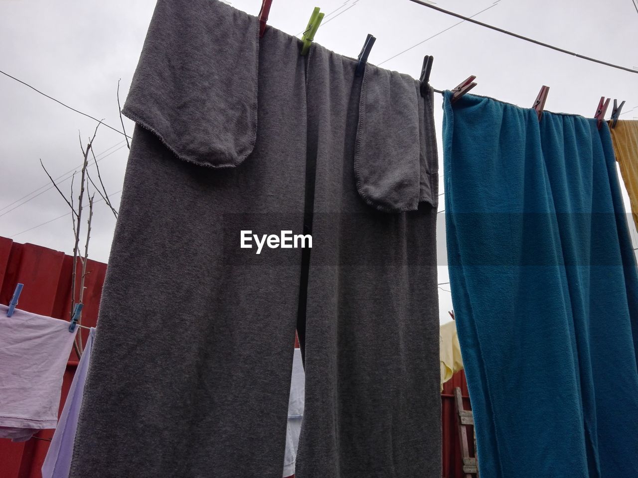 CLOSE-UP OF CLOTHES DRYING ON RACK