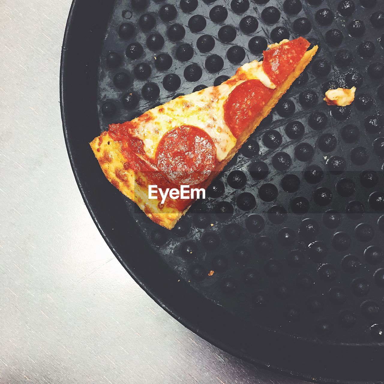 High angle view of pizza slice in tray on table