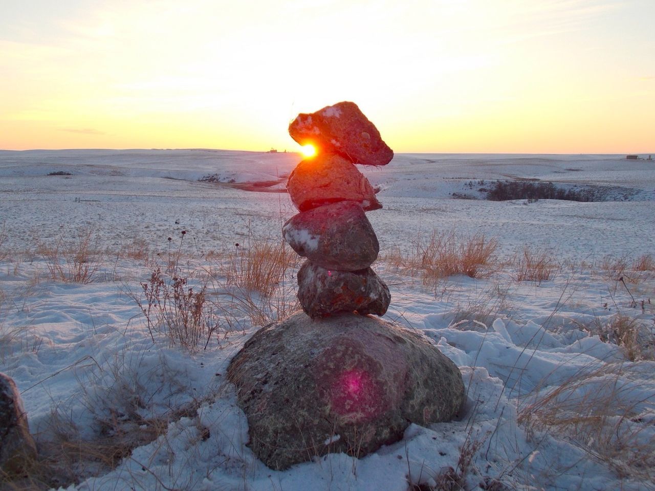 Stack of stones in winter meadow