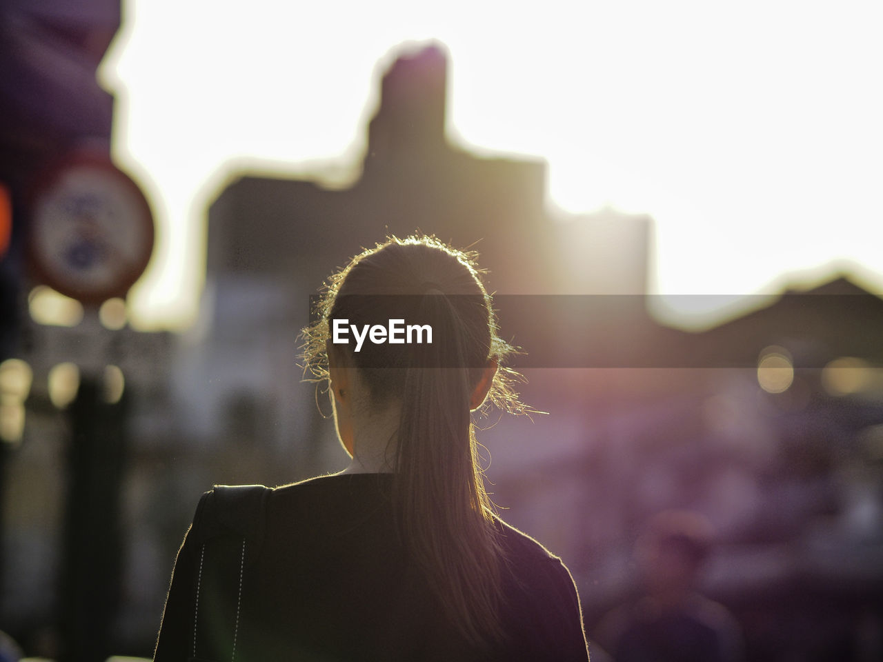 Rear view of woman walking in city