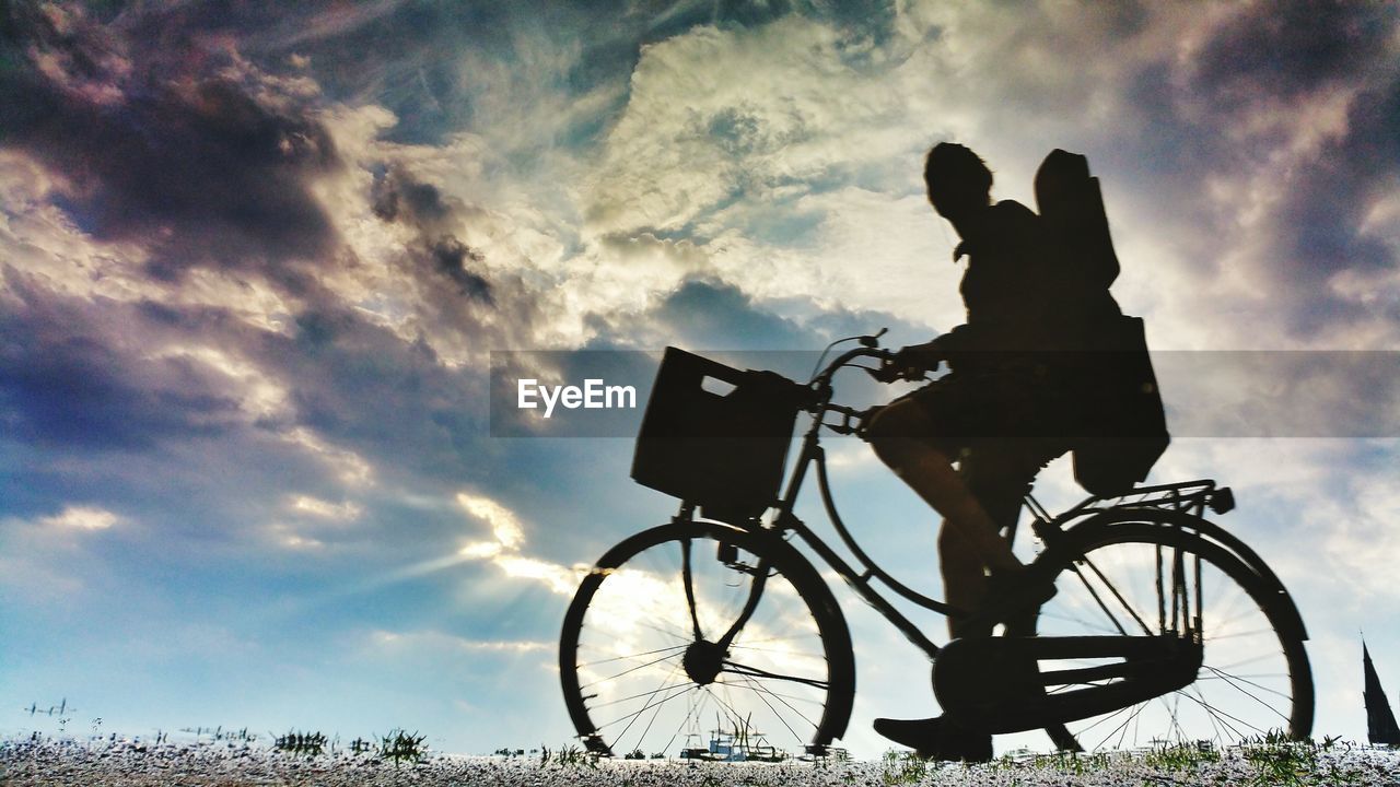 Low angle view of silhouette bicycle against sky during sunset