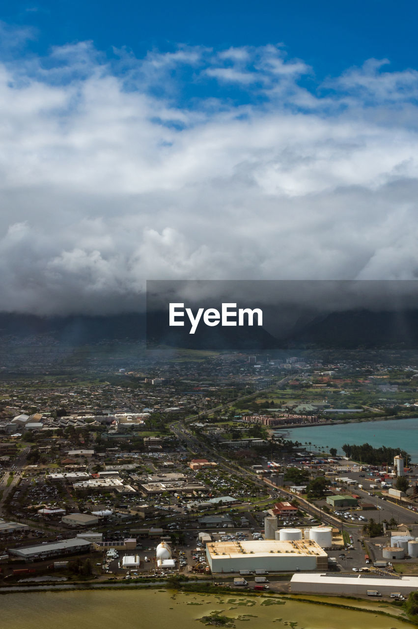 AERIAL VIEW OF TOWN AND SEA AGAINST SKY