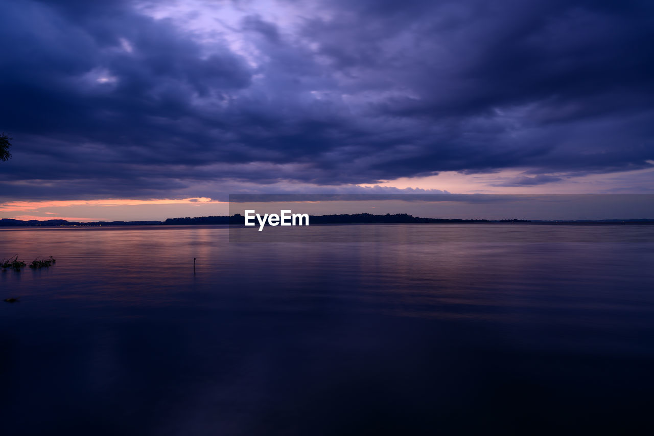 sky, water, cloud, reflection, sea, beauty in nature, horizon, scenics - nature, nature, dramatic sky, sunset, dawn, tranquility, environment, tranquil scene, cloudscape, evening, no people, ocean, landscape, night, beach, seascape, storm, outdoors, land, darkness, travel destinations, dark, blue, travel, overcast, moody sky