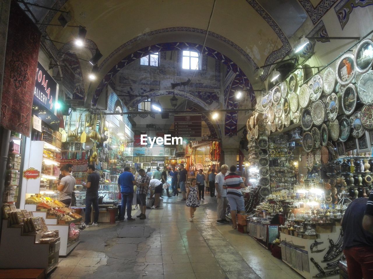 PEOPLE AT ILLUMINATED MARKET