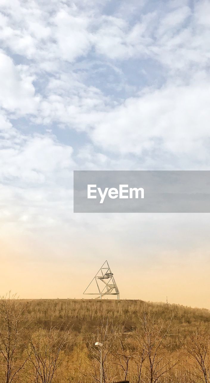 WINDMILL ON FIELD AGAINST SKY