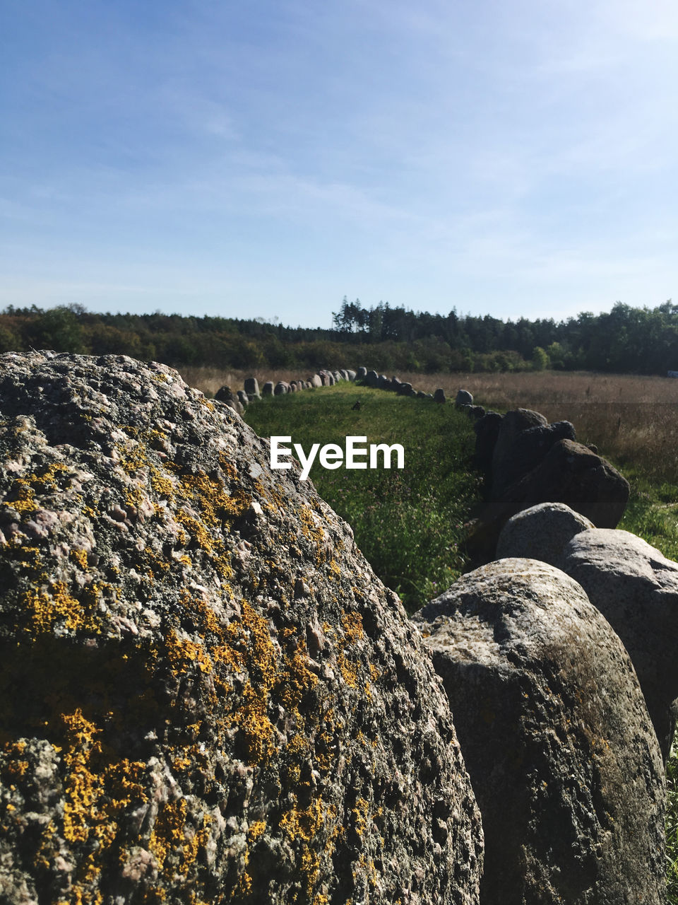ROCKS ON LAND AGAINST SKY