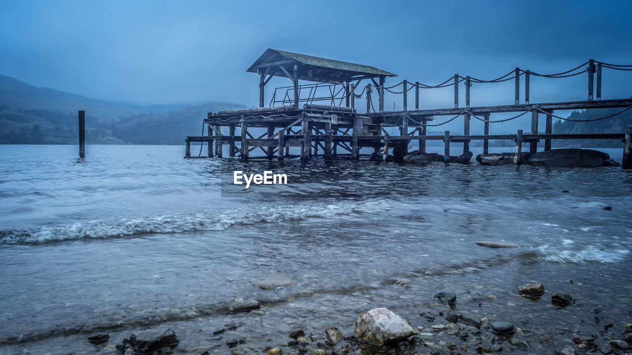 VIEW OF PIER ON BEACH AGAINST SKY