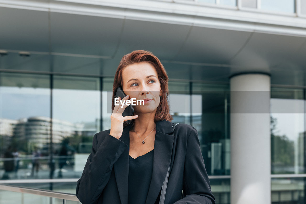 businesswoman talking on phone in city