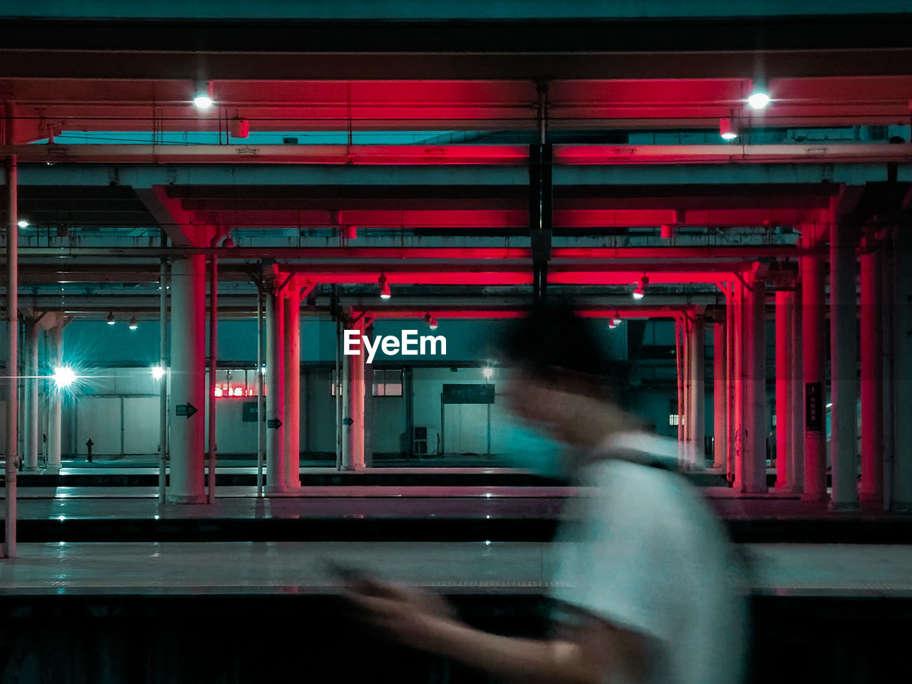 Side view of man in illuminated red light at night