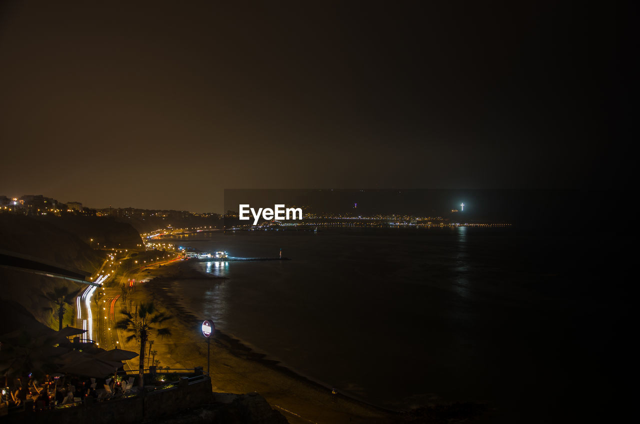 VIEW OF ILLUMINATED CITYSCAPE AT NIGHT