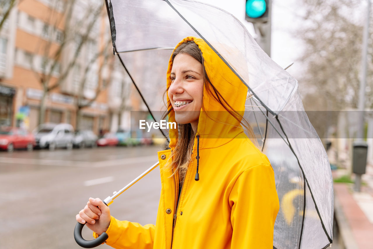 Portrait of young woman holding umbrella