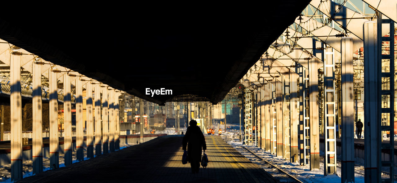 Person walking at railroad station