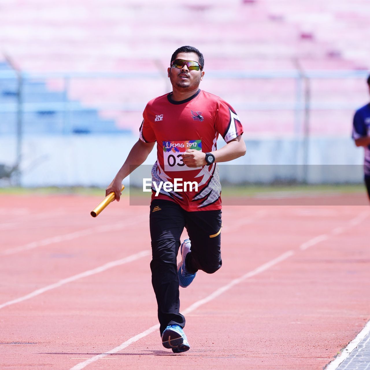 Full length portrait of man running on track