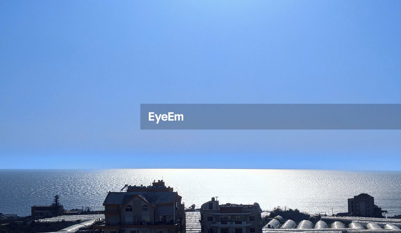 PANORAMIC VIEW OF SEA AGAINST BUILDINGS IN CITY