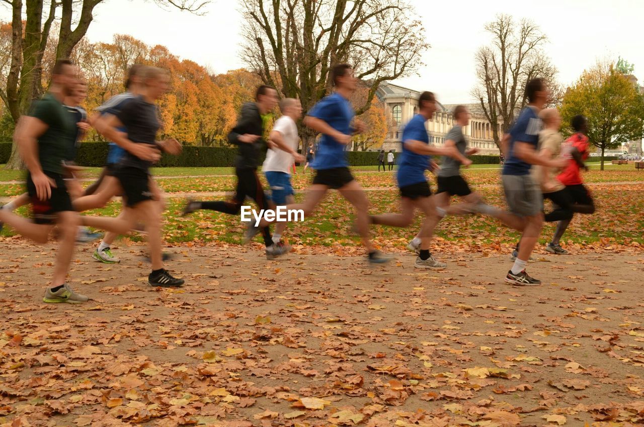 PEOPLE RUNNING ON FIELD