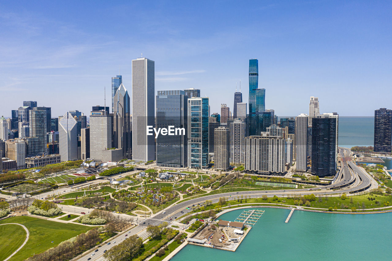 Aerial view of buildings in city against sky