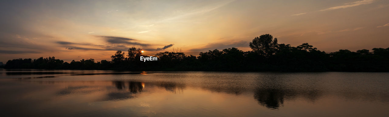 Scenic view of lake against sky during sunset