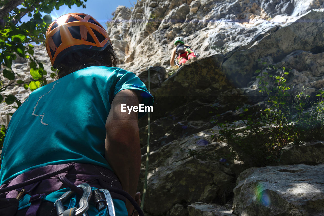 Two climbers and a reflection in the helmet