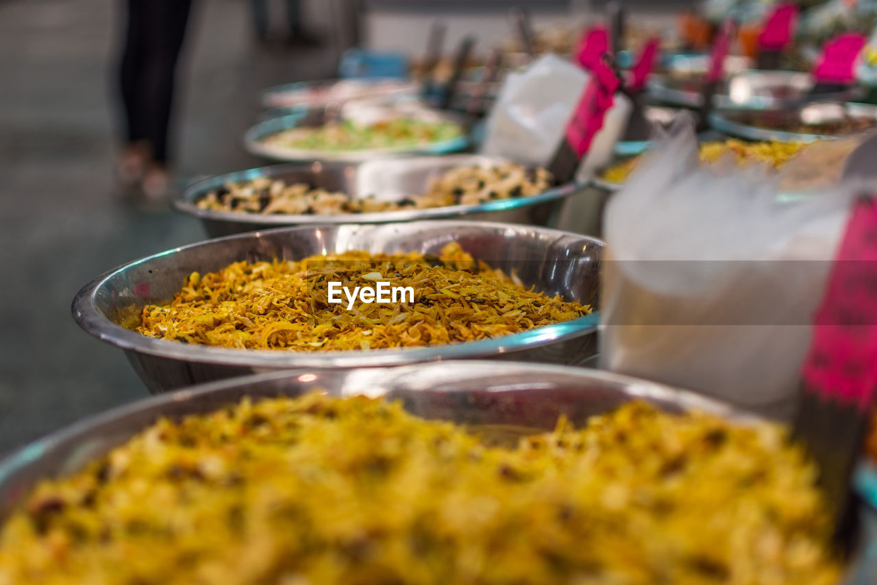 Close-up of spices in containers at market stall