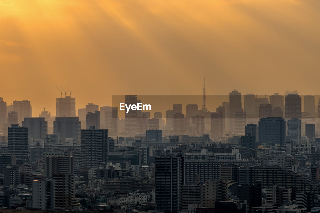 Scene of tokyo tower locate with various building cityscape at sunset time