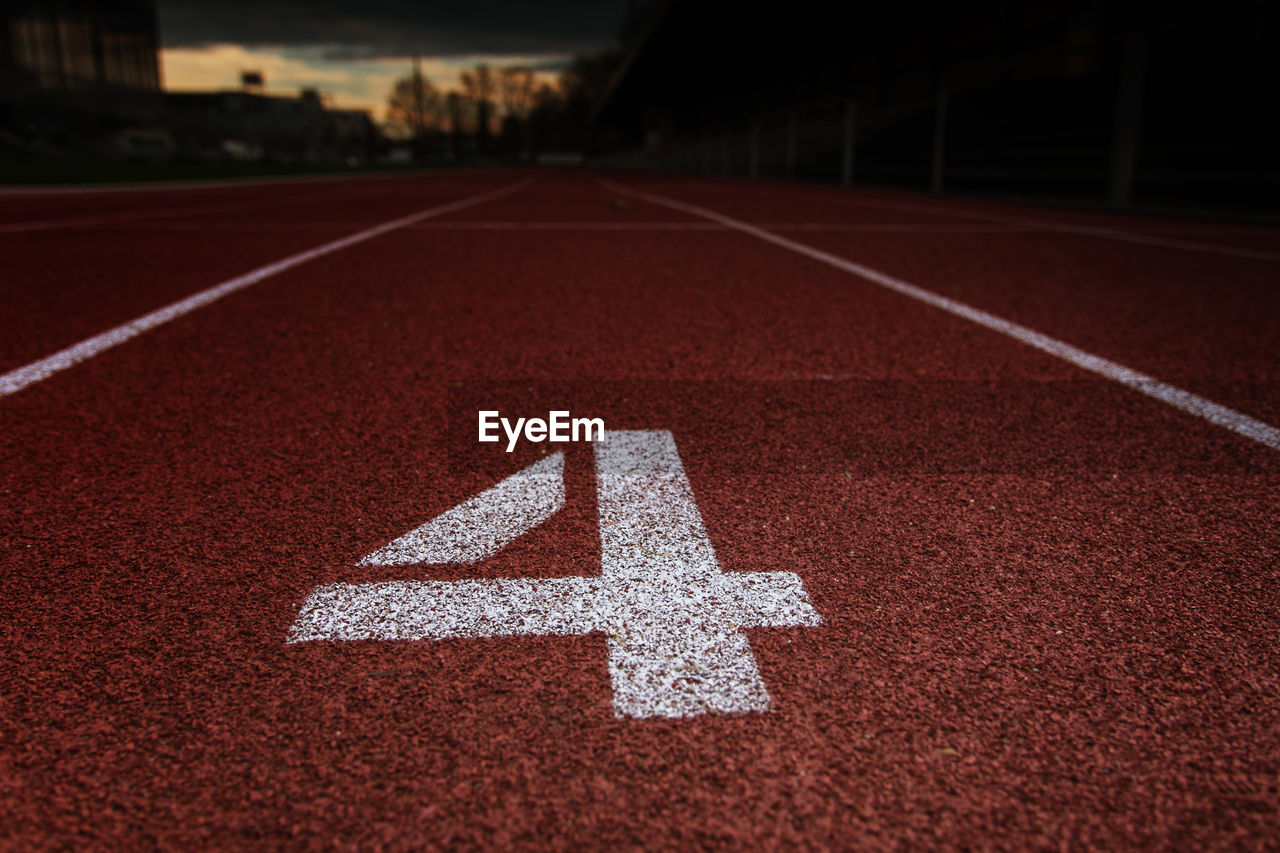 Close-up of arrow symbol on empty road