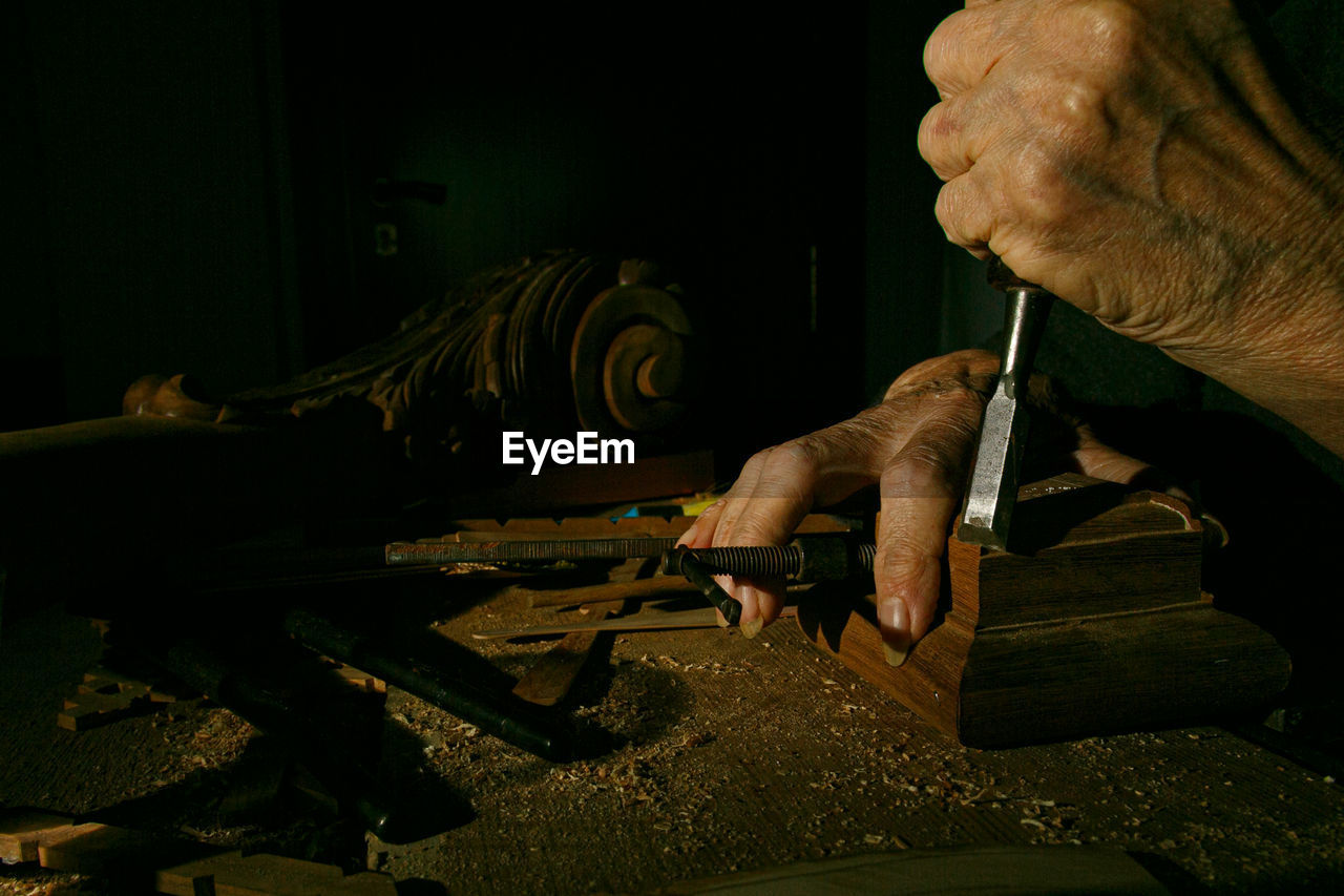 cropped hand of man working at workshop