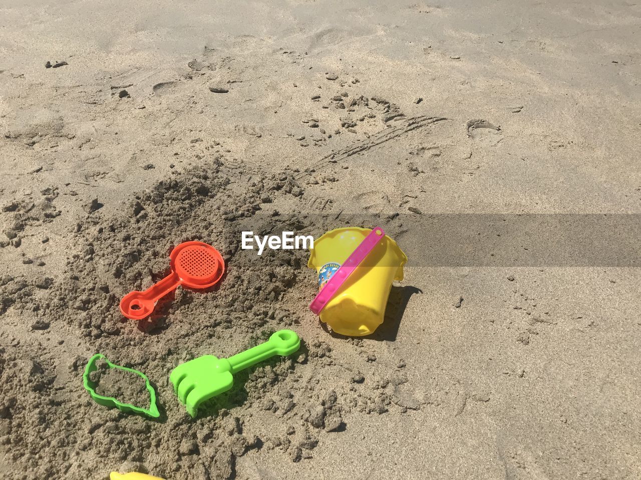 HIGH ANGLE VIEW OF TOYS ON BEACH