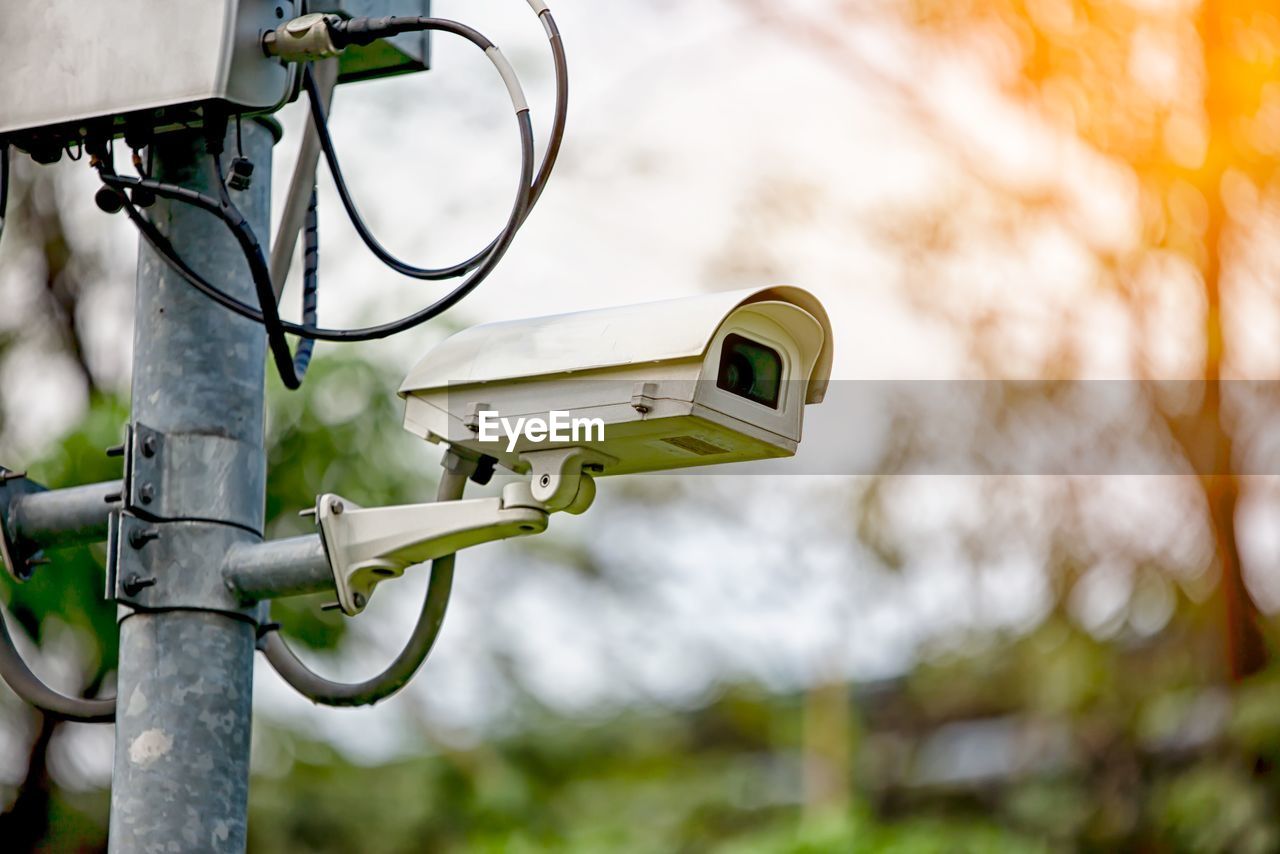 Low angle view of security camera on pole