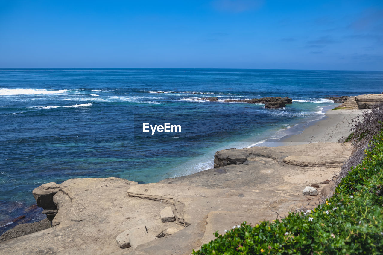 Scenic view of sea against blue sky