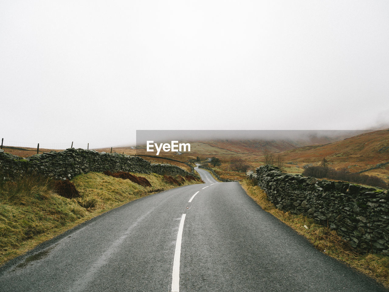 Road amidst mountains against sky