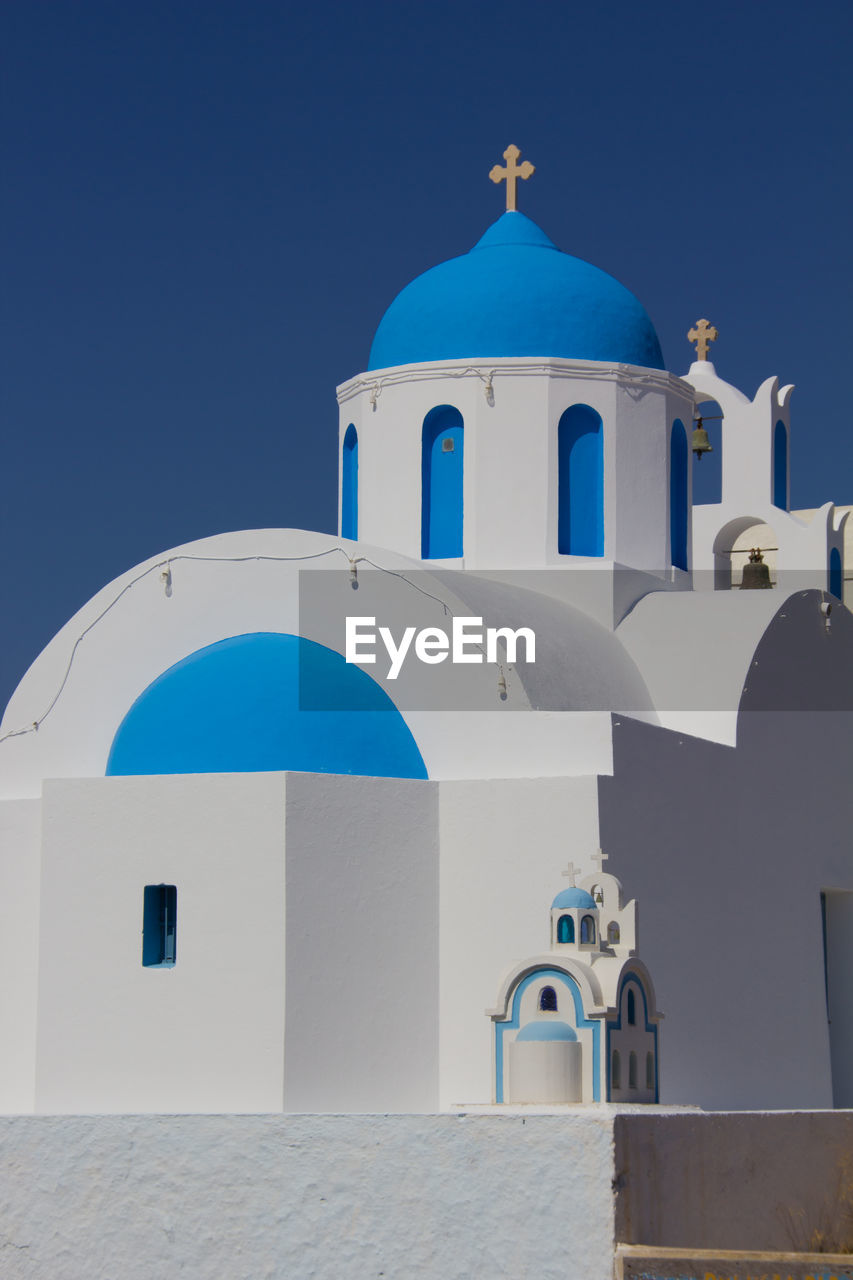 Low angle view of church against clear blue sky